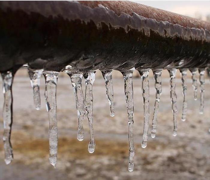 Frozen pipe with icicles