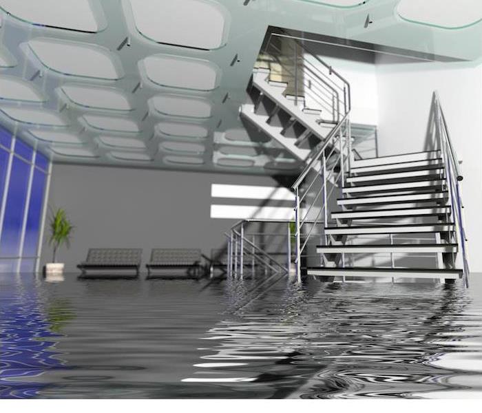flooding in large room with staircase partially submerged in water