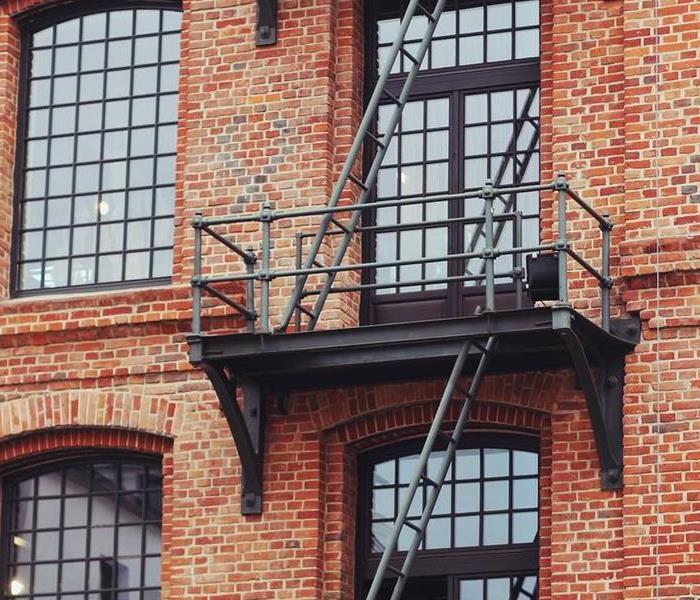 2 fire escapes on a red brick building. 
